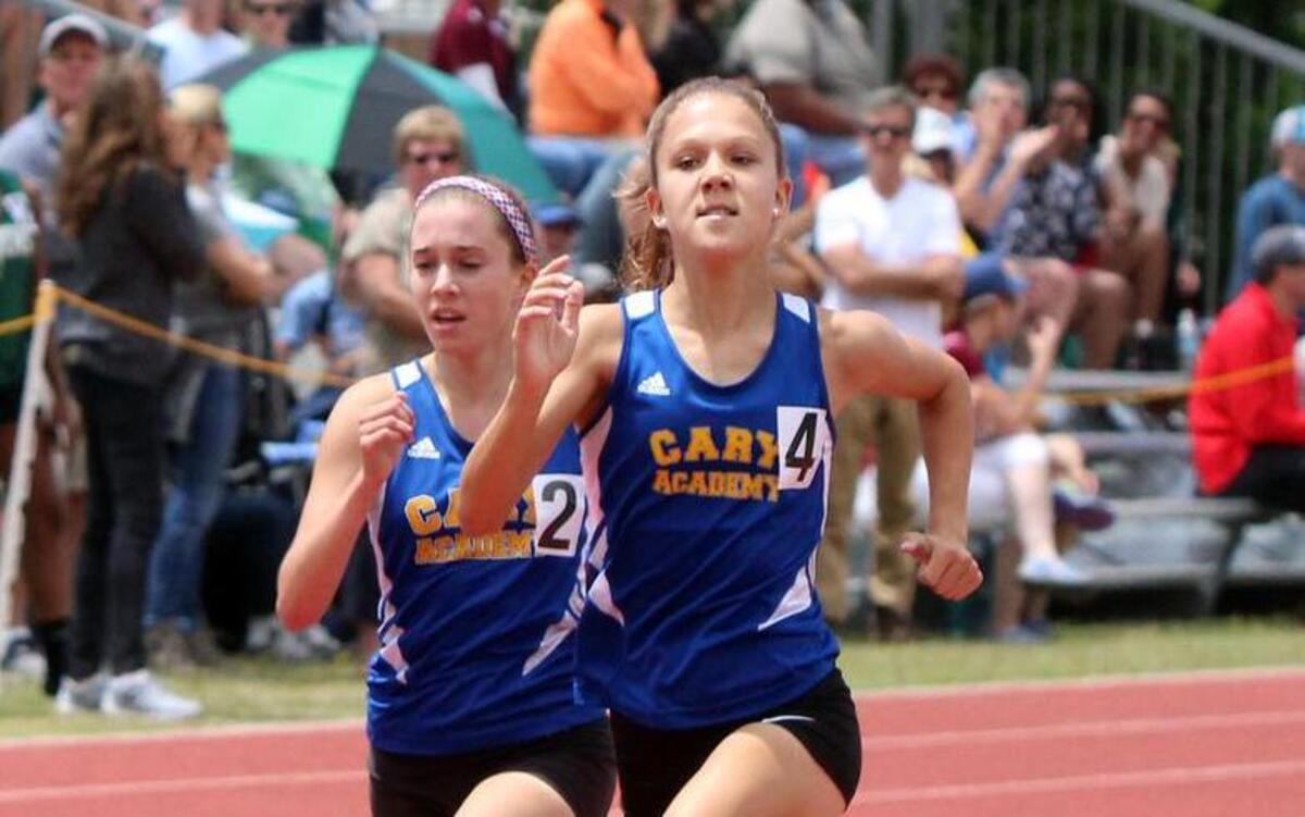 Cary Academy’s Olivia Frazier (right) overtakes teammate Sarah Bodmer on the final stretch of the girls' 1600 meter run during the NCISAA 3A state track and field championships hosted by Campbell University in Buies Creek, N.C. on Saturday, May 21, 2016.