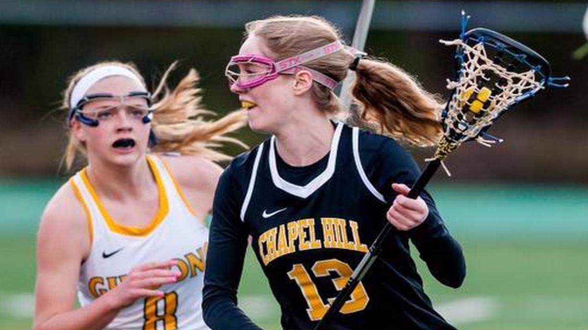 
Chapel Hill's senior Taylor Adam's (13) attempts to get past Cardinal Gibbon's sophomore Jordan Lappin (8) during a game March 20.
