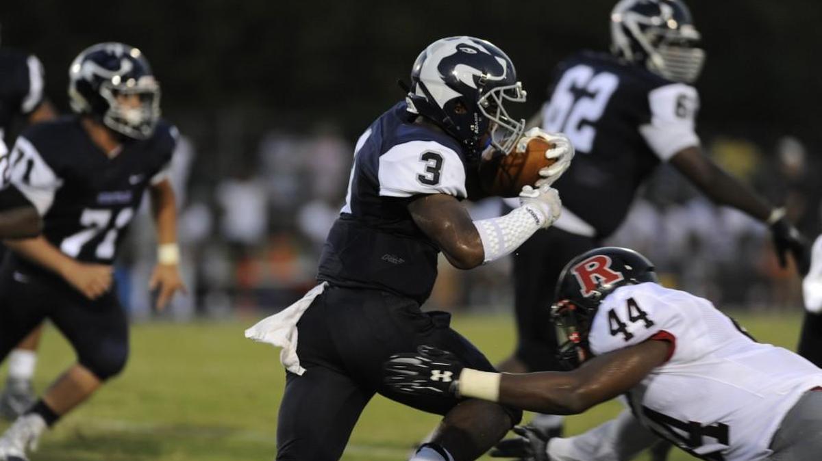 Heritage running back Ricky Person, who has run for 223 yards and two touchdowns this year, makes a Rolesville football player during the Huskies’ 28-0 win on Friday.