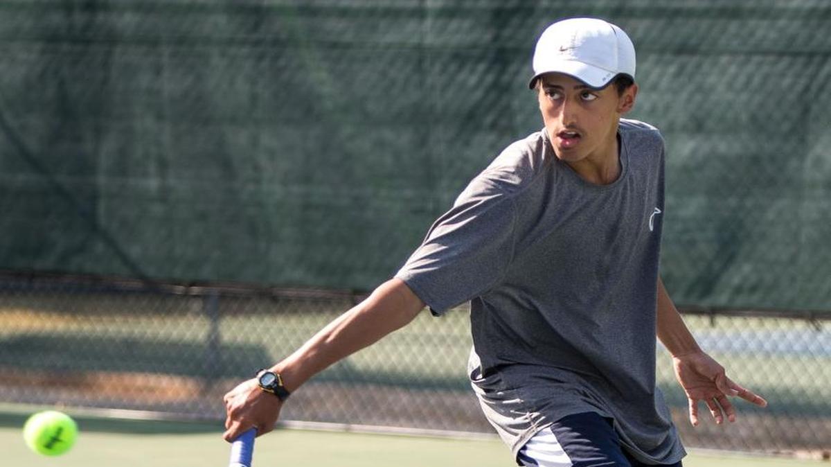 Millbrook's Mohamed Almontaser hits a ball during the Cap-8 tennis finals at Millbrook Exchange Park in Raleigh on Wednesday, Apr. 27, 2016.