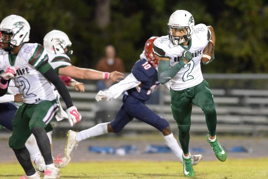 Jordyn Adams (2) of Green Hope carries the ball against the pursuit of Myles Speller (10) of Jordan. The Green Hope Falcons visited the Jordan Falcons in a high school football game on Oct. 27, 2017. Green Hope won 48-20.