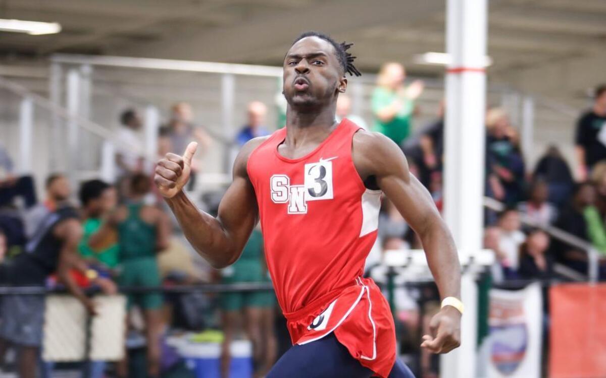 Southern Nash's Nadir Thompson looks to the clock as he prepares to lean into the finish line, winning the 300 meter dash during the NCHSAA 3A indoor track state championship in Greensboro on Saturday, February 11, 2017.
