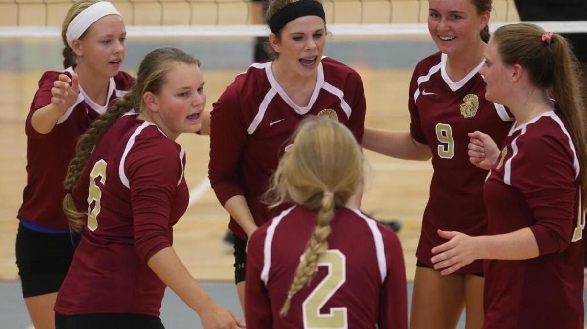 The Harnett Central volleyball team celebrates a point during the Trojan Invitational at South Garner High School on Saturday, Aug. 20, 2016. Harnett Central defeated Garner 3-2 for the win. See the full story at nando.com/preps .