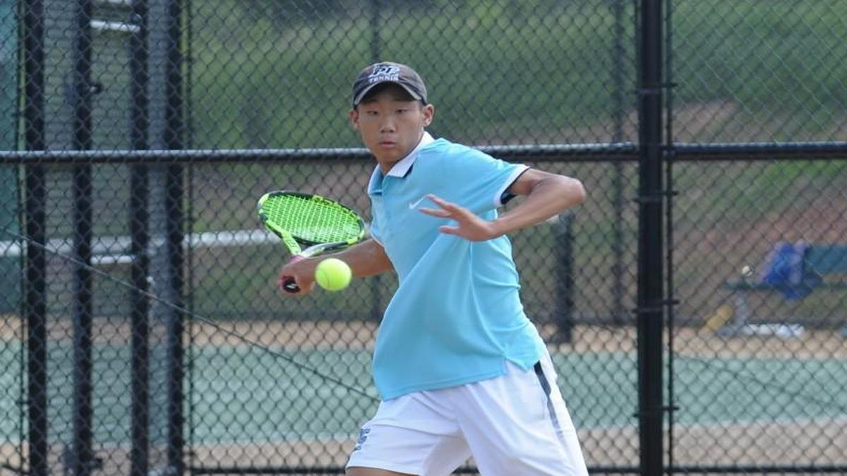 Panther Creek's Alex Kim returns a volley during the boys tennis match against Cardinal Gibbons, which was played in Raleigh on Monday, May 15, 2017.