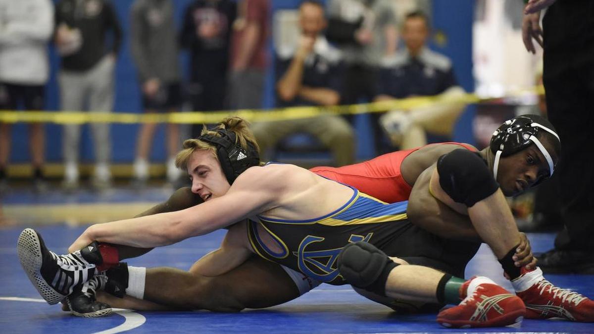 Christian Sodano wrestles Wesleyan Christian’s Cameron Johnson in the 128 pound weight class at the NCISAA State Wrestling Tournament in Cary on Saturday.