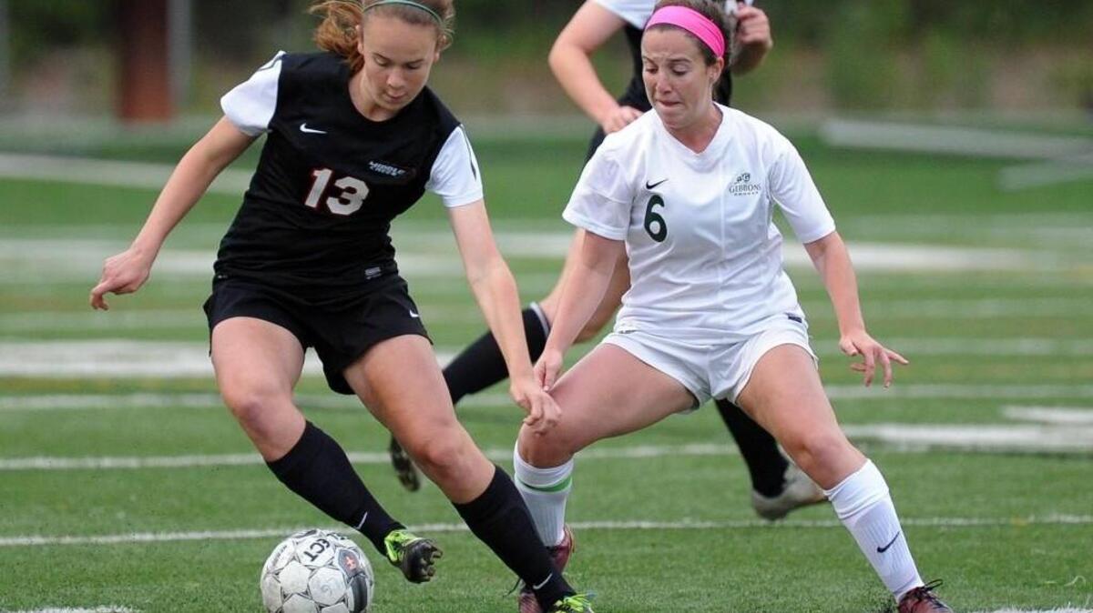Middle Creek's Mattie Murphy (13) controls the ball in front of Cardinal Gibbons' Abbey Burns (6) during the NCHSAA third round 4A girls soccer playoff game, which was played in Raleigh on Wednesday, May 18, 2016. Middle Creek won 1-0 in overtime.