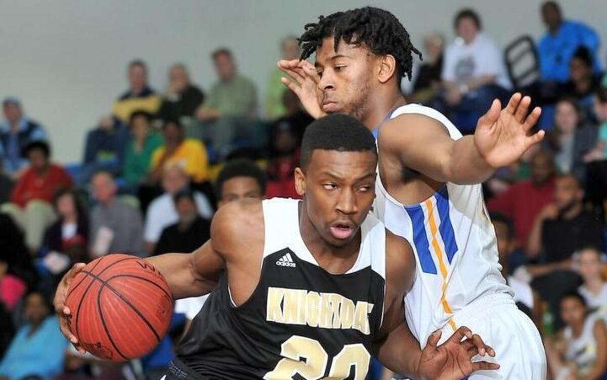 Knightdale's Jordan Shannon (20) drives to the lane against Garner's Javonte Sims (15) during the first half. The Knightdale Knights took on the Garner Trojans in basketball at Garner High in Garner, N.C. on Friday, February 5, 2016. Garner wins 87-70.