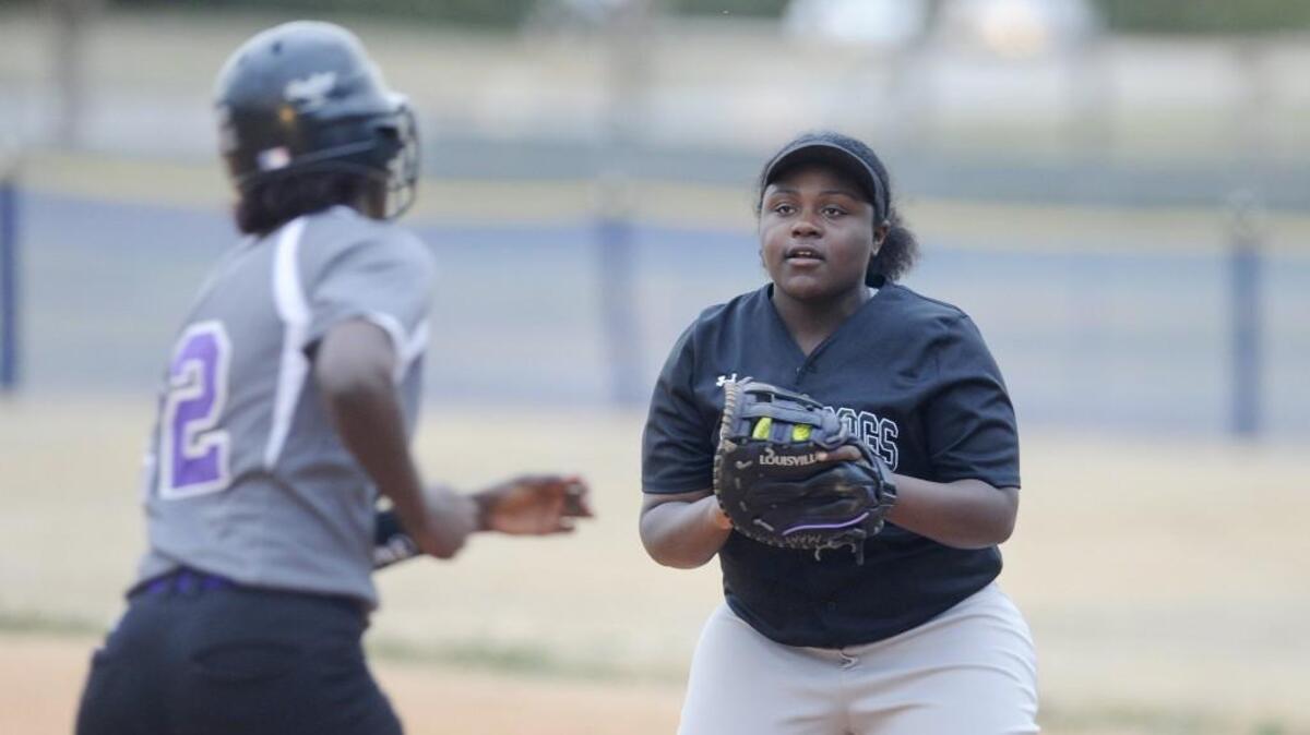 Southeast Raleigh's Morgan Murph (19) tags out Broughton's Davia Ingram (2) at first in Raleigh, N.C. on Tuesday, March 7, 2017.