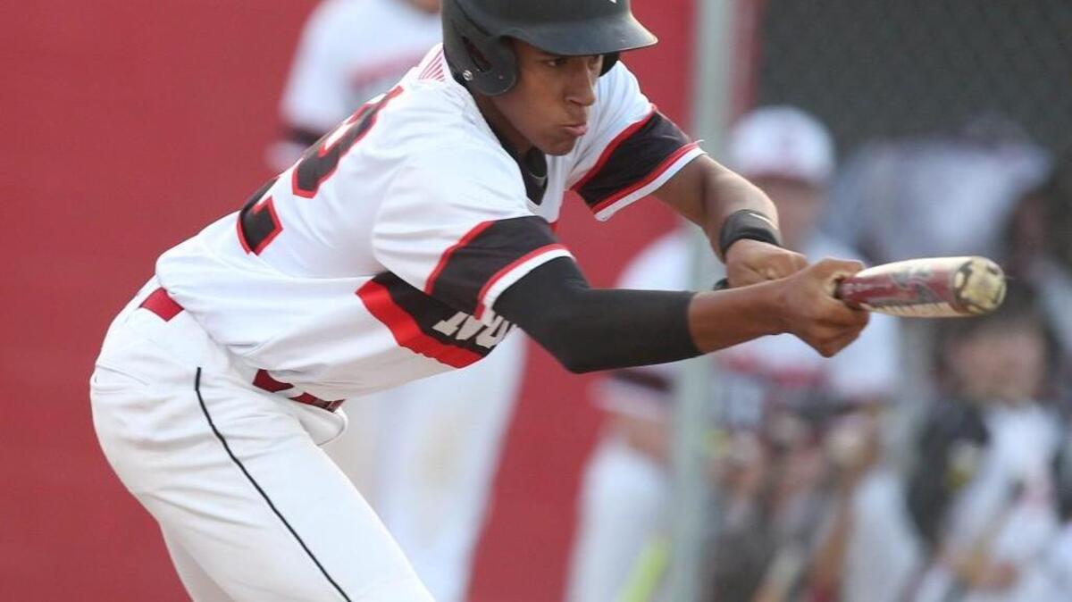 North Johnston's Trey Whitley (12) goes for the bunt during the North Johnston Panthers High School baseball game against the SouthWest Edgecombe Cougars on April 19, 2016, in Kenly, N.C. North Johnston won the game 2-1.