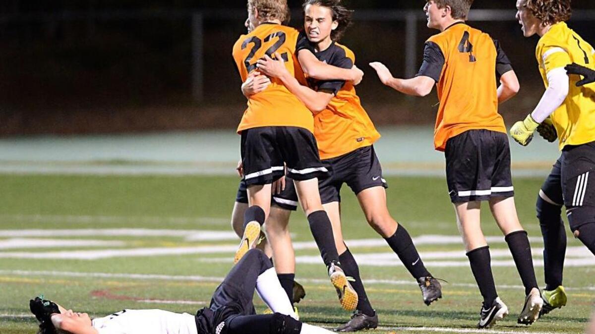 New Hanover celebrate the win after the final whistle. The Cardinal Gibbons Crusaders played the New Hanover Wildcats in Raleigh, N.C. on Saturday, November 14, 2015. New Hanover won 2-1.