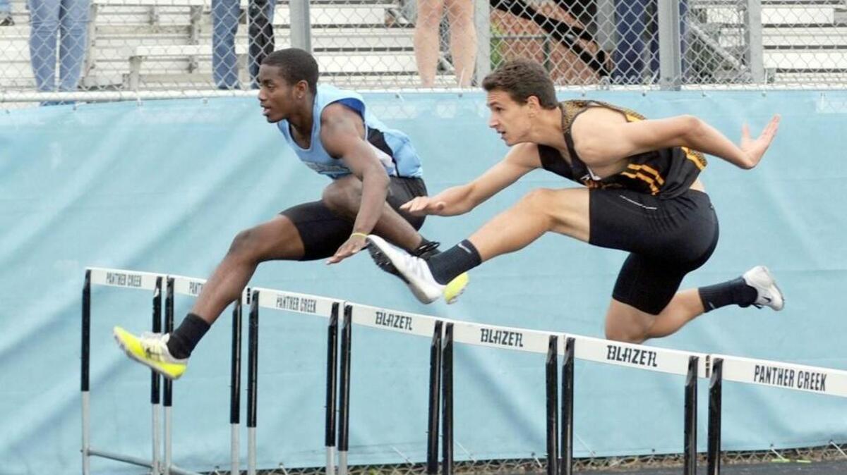 Panther Creek's Brandon Holmes (left) and Apex's Lucas Nativio compete in the Boys 110 Meter Hurdles at the SWAC Track & Field Championships, which took place in Cary on Thursday, May 5, 2016.