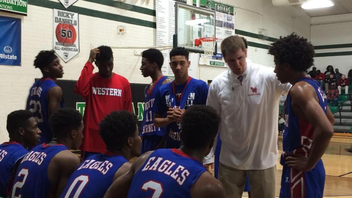 Western Harnett boys basketball coach Seth Womble talks to his team during a timeout of a NCHSAA 3A first boys basketball playoff game on Feb. 21, 2017 at West Brunswick.