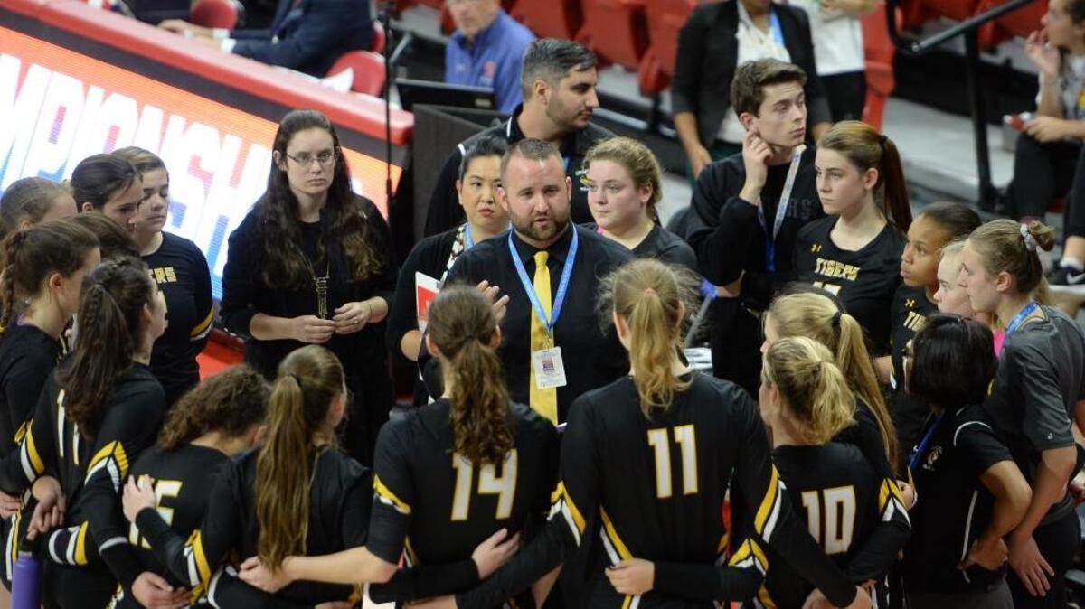 Ross Fields, center, head coach of Chapel Hill instructs his players during a timeout. The Chapel Hill Tigers played the Cox Mill Chargers for the NCHSAA 3A volleyball championship that took place at the N.C. State Reynolds Coliseum in Raleigh, N.C. on Saturday, November 5, 2016. Cox Mill won 3-0.