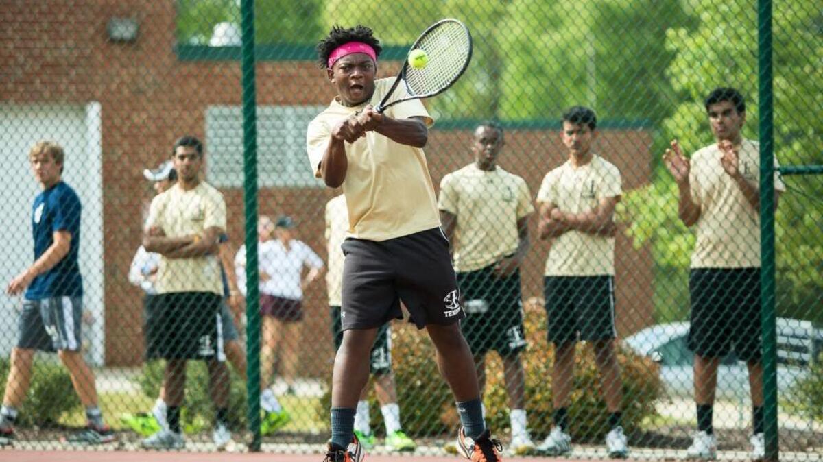 Enloe’s Michael Ogundele swings at a ball during a high school tennis match against Millbrook in Raleigh, N.C. on Tuesday, April 19, 2016.