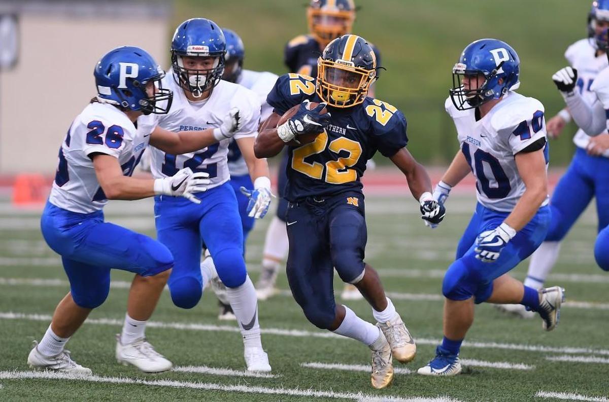 Daylan Felton (22) of Northern moves the ball against Alex Gravitt (26), Nick Jimenez (12) and Nick Harris (10) of Person. The Northern Knights played the Person Rockets in a football game that took place in Durham, N.C. on Friday, August 26 2017.