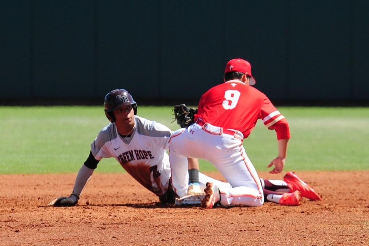 Green Hope’s Jordyn Adams (left) is tagged out at second base by orange Lutheran’s Zach Lew (9). The Green Hope Falcons and the Orange Lutheran Lancers played the championship baseball game in the National High School Invitational tournament in Cary on Saturday, March 31, 2018.