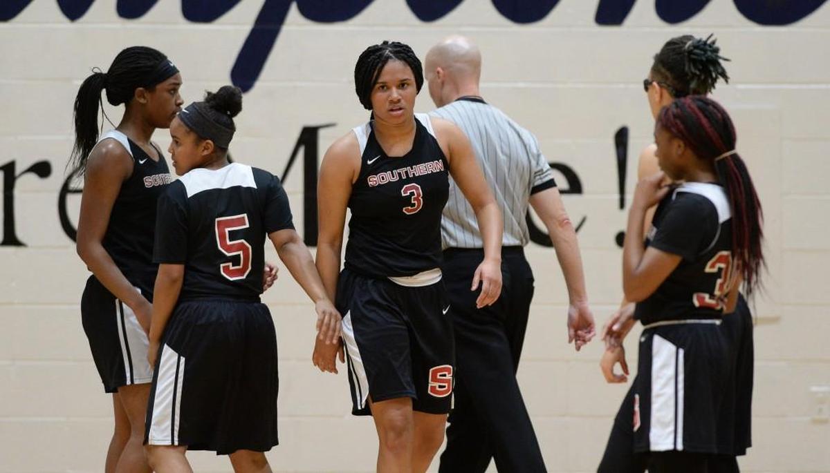 J'Naya Ephraim (3) of Southern Durham is congratulated by her teammates after scoring for the Spartans. The Hillside Hornets and the Southern Durham Spartans played in the Big Eight 3A Conference girls basketball tournament championship on Feb. 16, 2018.