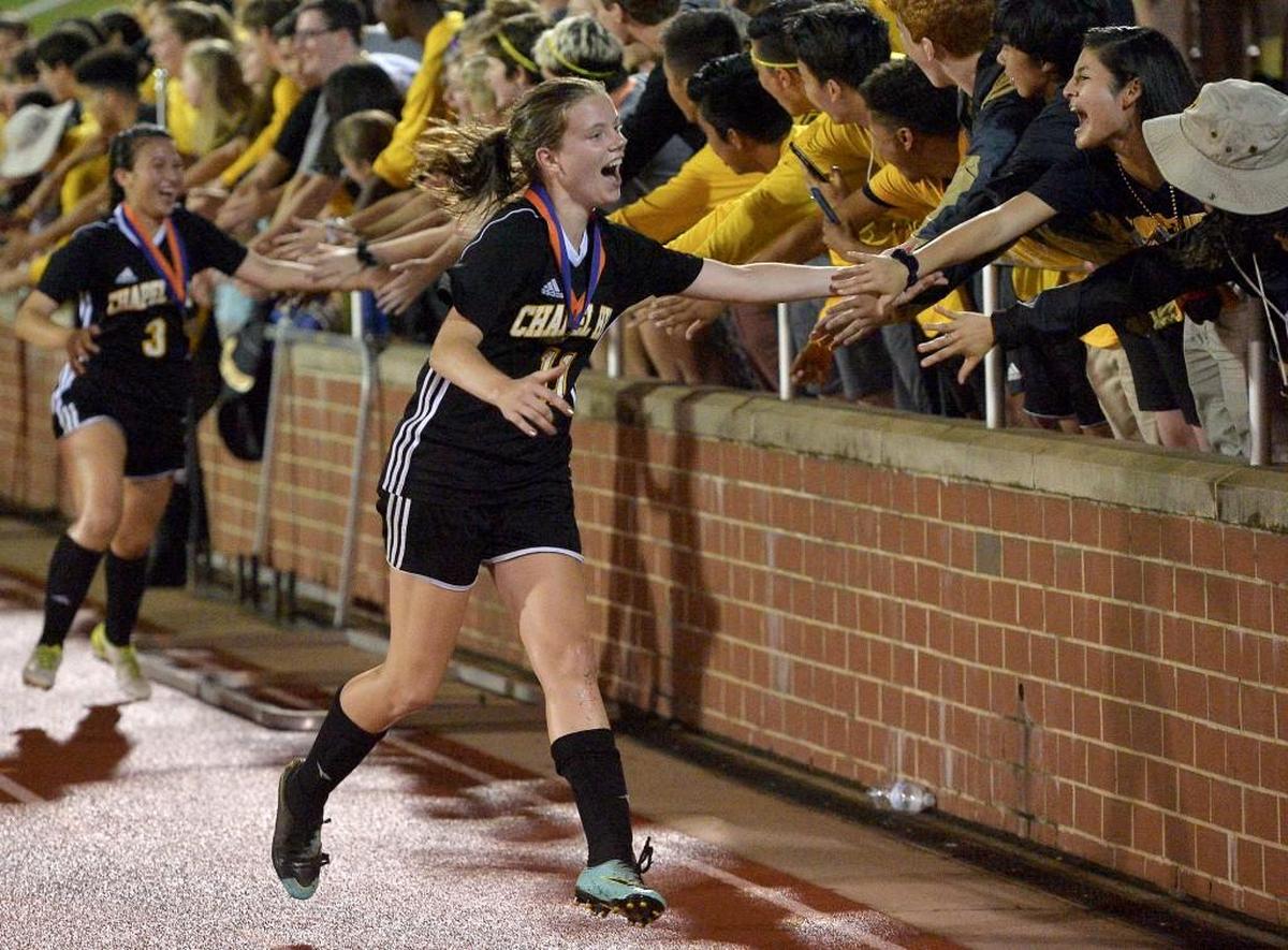 Chapel Hill's Elise Ederle celebrates with fans after their defeat of Cox Mill in the Girls 3A Soccer Championhship. The Chapel Hill Tigers and the Cox Mill Chargers met in the NCHSAA 3A Girl Soccer Final in Raleigh, N.C. on May 26, 2018. Chapel Hill wins the title 1-0.