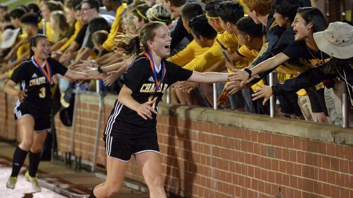 Chapel Hill's Elise Ederle celebrates with fans after their defeat of Cox Mill in the Girls 3A Soccer Championhship. The Chapel Hill Tigers and the Cox Mill Chargers met in the NCHSAA 3A Girl Soccer Final in Raleigh, N.C. on May 26, 2018. Chapel Hill wins the title 1-0.