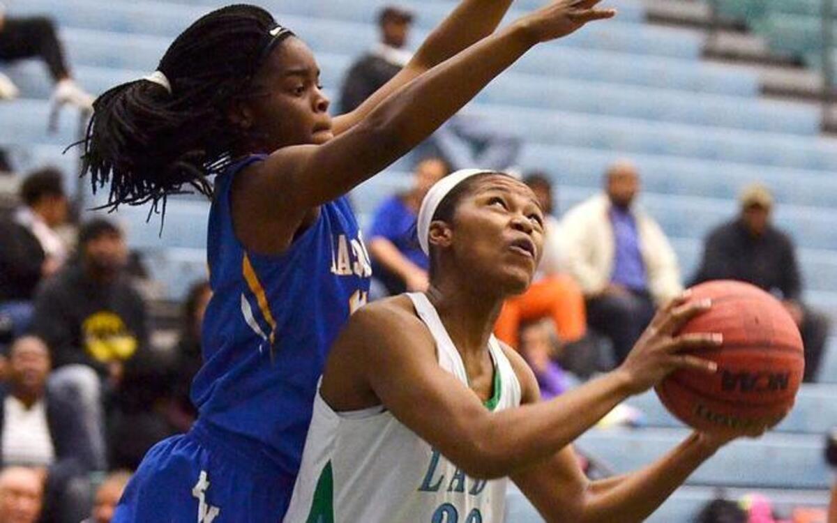 East Wake’s Mikieja Covington defends a look at a shot by Rose’s Jillian Ebron (30) in their game in the second round of the N.C. High School Athletic Association 4A girls basketball playoffs in Greenville, N.C. Thursday, Feb. 25, 2016.