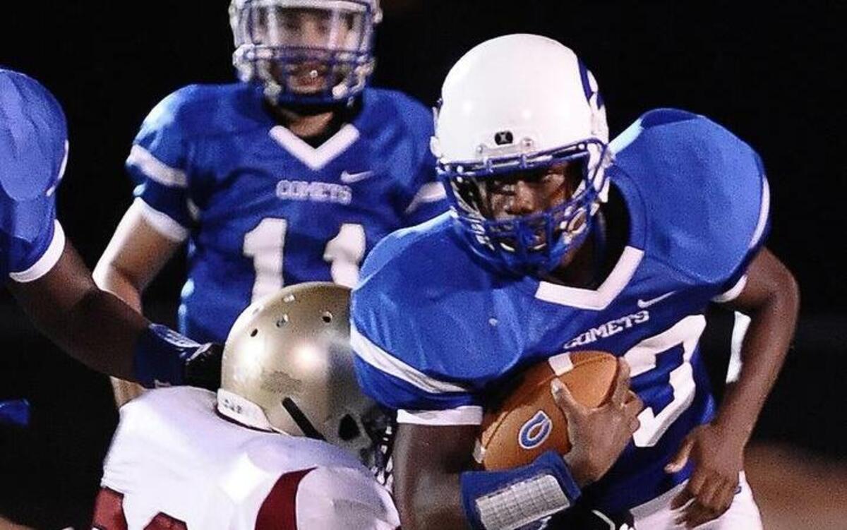 (33) tries to break away from Harnett Central's Jamal McKoy (32), during Clayton's football game against Harnett Central.