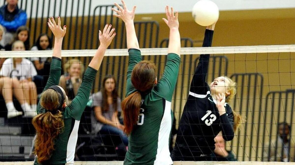 Green Hope's Kara Adams (left) and Allioson O'Connor try to block a shot by Panther Creek's Cassie Zietlow (13) during the volleyball game in the second round of the NCHSAA playoffs on Tuesday, October 27, 2015 in Cary. Panther Creek won 3-2.