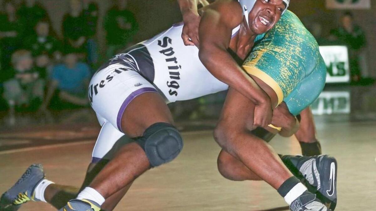 Holly Springs’ Zion Cooke ties up with West Forsyth's Sean Foster in the 182 pound weight class but Foster gets the win for the Titans. Coverage from the NCHSAA 4A Dual Wrestling State Championship Match between the Golden Hawks of Holly Springs High School and the West Forsyth High Titans held in Clemmons, N.C. on Saturday, February 6, 2016. West Forsyth defeated Holly Springs 57-10 to win the championship.