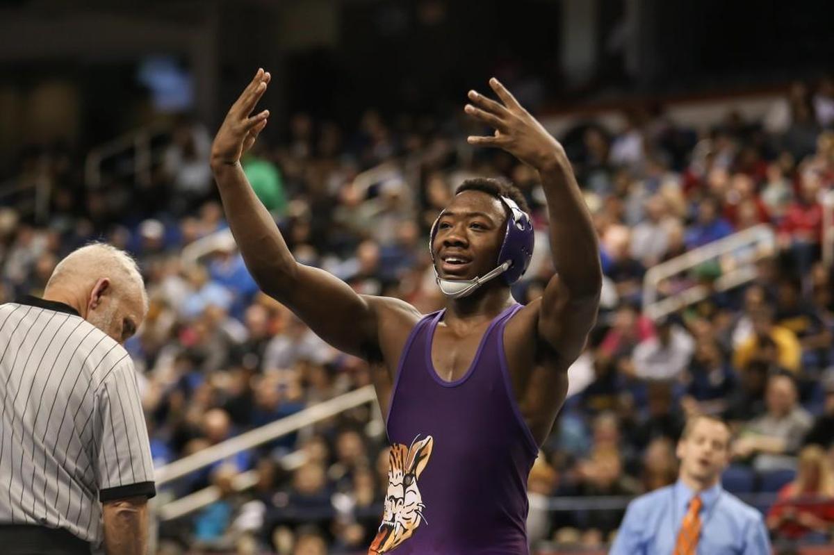 Carrboro's Quincy Monday, a four-time state champion, celebrates after winning the 152-pound 2A championship match during the NCHSAA State Wrestling Championships in Greensboro on Saturday, February 17, 2018.