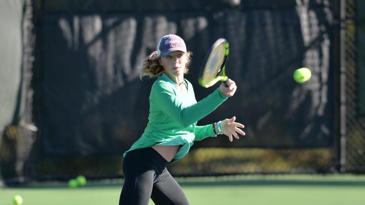 Sophia Gray of Green Hope hits a return during the women dual team tennis games between the Green Hope Falcons and the Myers Park Mustangs that took place at the Burlington Tennis Center in Burlington, N.C. on Saturday, November 12, 2016.