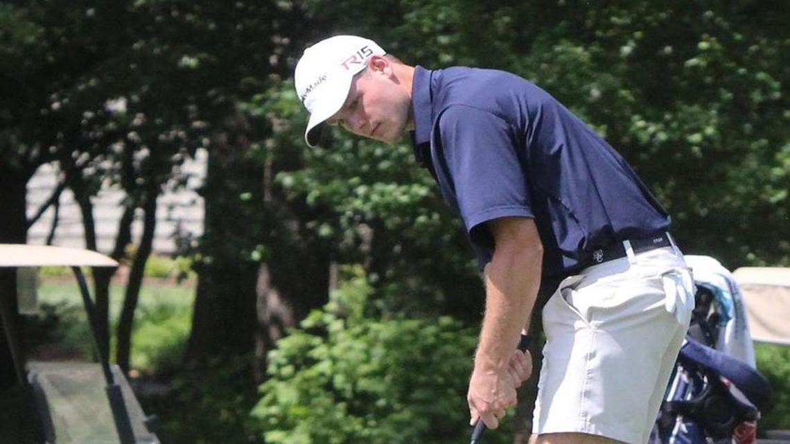Doc Redman sinks a birdie putt on No. 7 Monday during the boys’ golf 4A Mideast Regional at The Neuse Golf Club in Clayton.