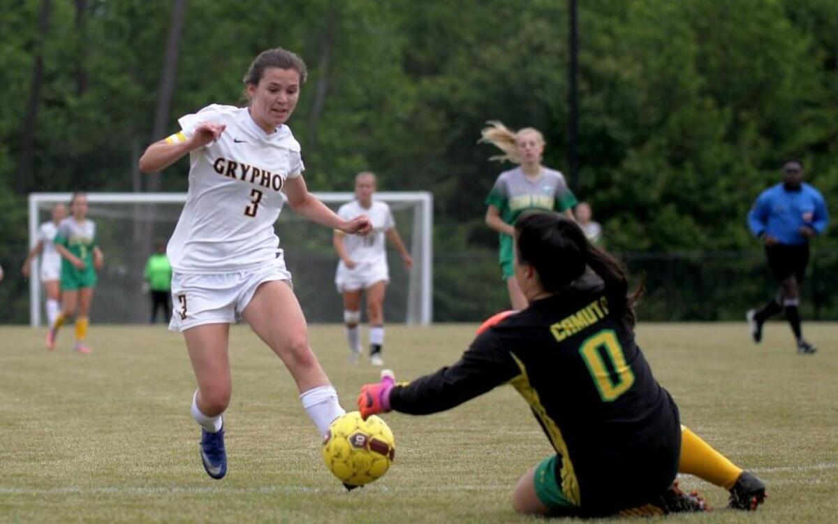 Eastern Alamance's goal keeper Marisa Camuto (0) arrives to the ball before Rocky Mount's Sarah Bland (3) could make the shot attempt during the Eastern Alamance High School girl's soccer game against Rocky Mount High School in Rocky Mount, N.C. on Tuesday, May 9, 2017.
