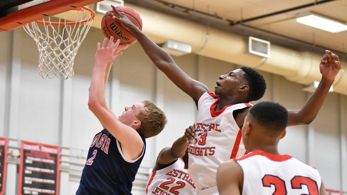 Marcotis Hall (13) blocks Voyager’s Blake Buchanan's (2 )shot during Voyager's basketball game at Kestrel Heights that took place in Durham, N.C. on Saturday, January 28, 2017.