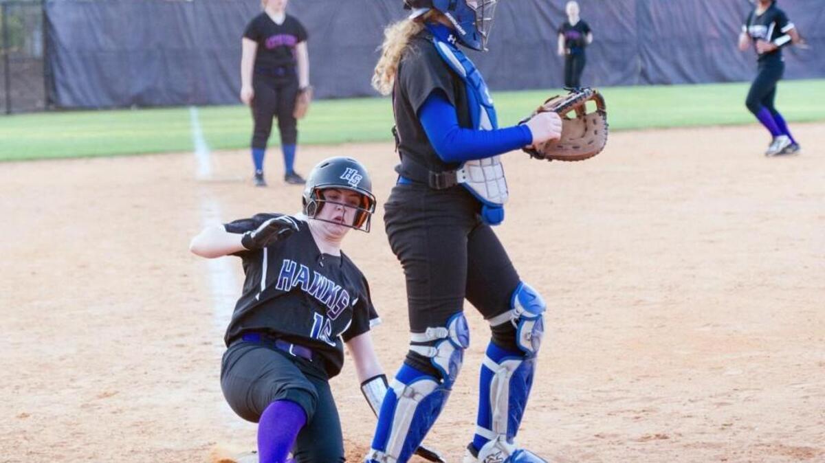 Holly Springs’ Mary-Kate Myers (16), slides into home. Holly Springs hosted Athens Drive on Tuesday, March 22, 2016. Holly Springs won 10-0.