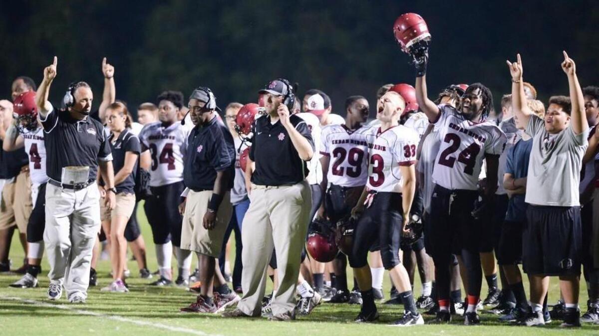 
Cedar Ridge head coach, Steve Johnson, left, and his team celebrate a touchdown in the fourth quarter. The East Chapel Hill Wildcats played the Cedar Ridge Red Wolves in Chapel Hill, N.C. on Thursday, September 3, 2015. Cedar Ridge won 29-6.
