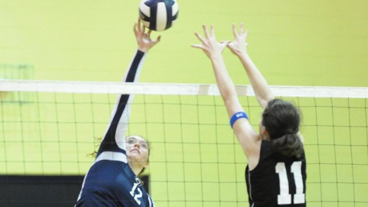 North Raleigh Christian's Ali Thanhauser (12) spikes the ball, which was blocked by Wilmington Christian's Georgia Davis (11) during the North Raleigh Christian Academy's volleyball tournament, which was played in Raleigh on Saturday, September 10, 2016.