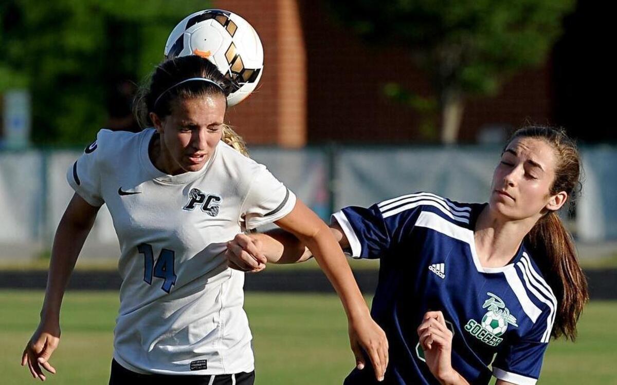 
Panther Creek's Lindsay Pasteris (14) and Leesville's Nevada Mareno (right) battle for a high bouncer during the third round of the NCHSAA girls soccer playoff game between the Leesville Road Pride and the Panther Creek Catamounts, which was played in Cary on Wednesday, May 20, 2015. Panther Creek won 2-0.
