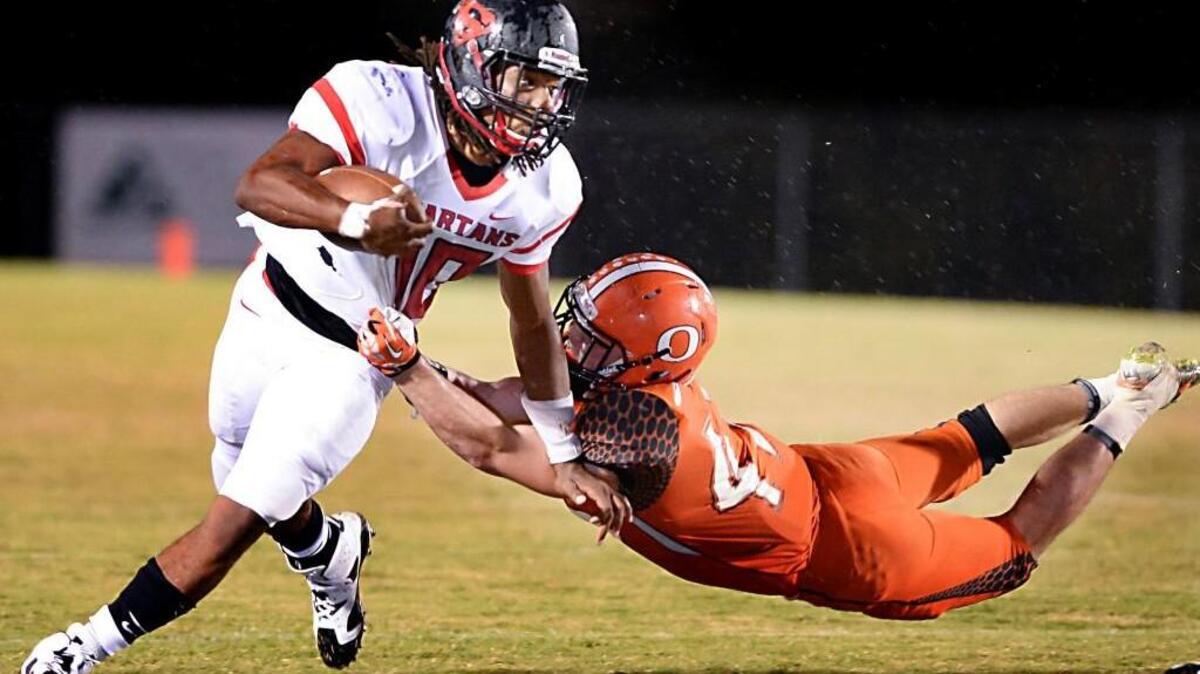 
Jordon Brown, left, of Southern gains yards against a tackle from Drew Lemaster, right, of Orange on Sept. 24. Brown committed to North Carolina as a Rivals.com 4-star prospect ranked the No. 5 all-purpose back in the nation and No. 11 recruit in the state. 
