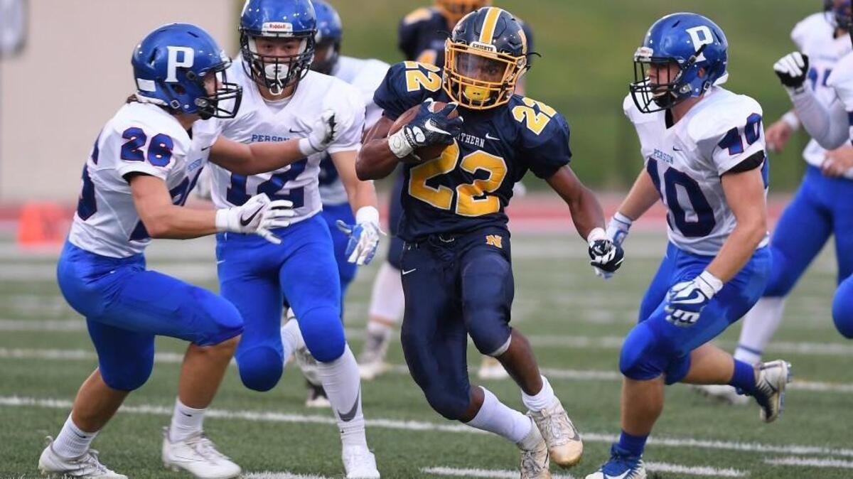 Daylan Felton (22) of Northern moves the ball against Alex Gravitt (26), Nick Jimenez (12) and Nick Harris (10) of Person. The Northern Knights played the Person Rockets in a football game that took place in Durham, N.C. on Friday, August 26 2017.