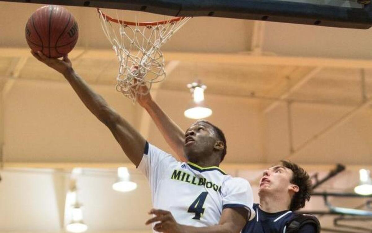 Millbrook's Faison Brock goes up for a shot as Leesville's Eric Scollard (34) defends during a high school basketball game in Raleigh, N.C. on Thursday, Jan. 21, 2016. Millbrook won 78-52.