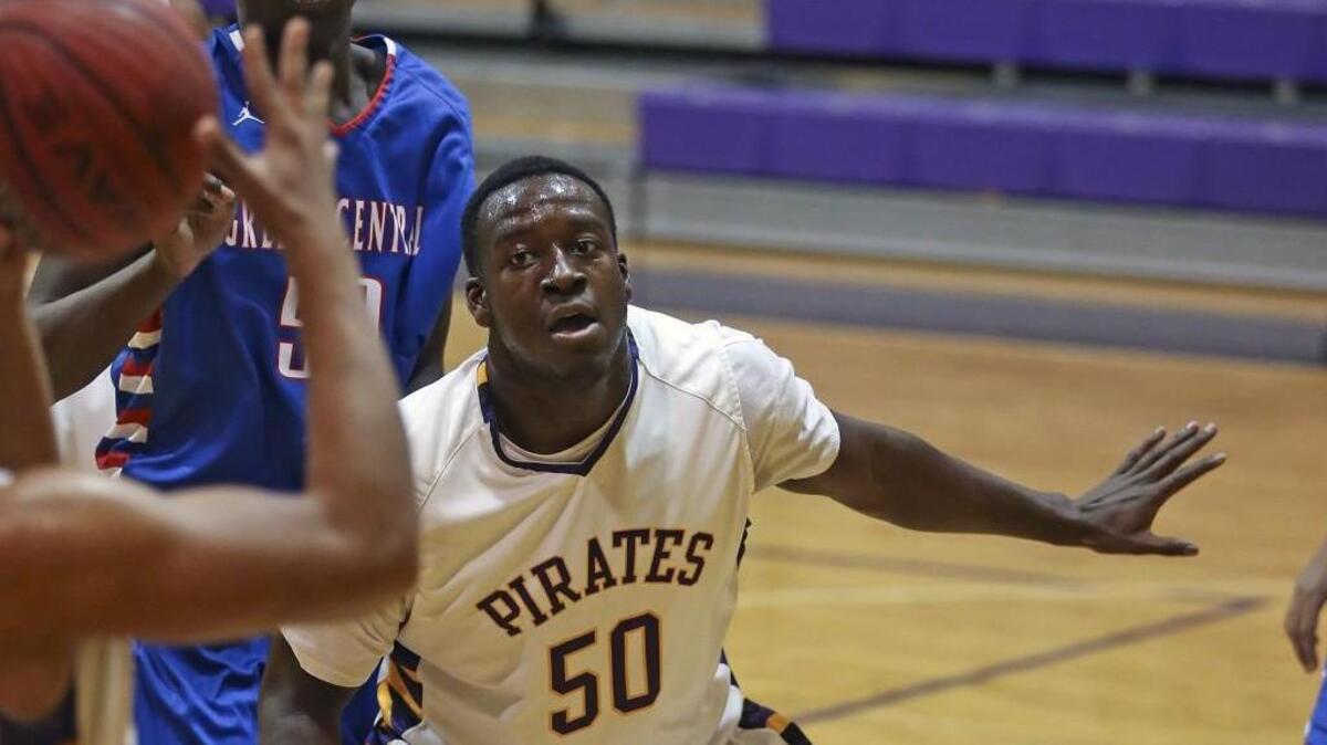 Corinth Holders’ Trey Adams boxes out Greene Central’s Imajae Dodd under the basket.
