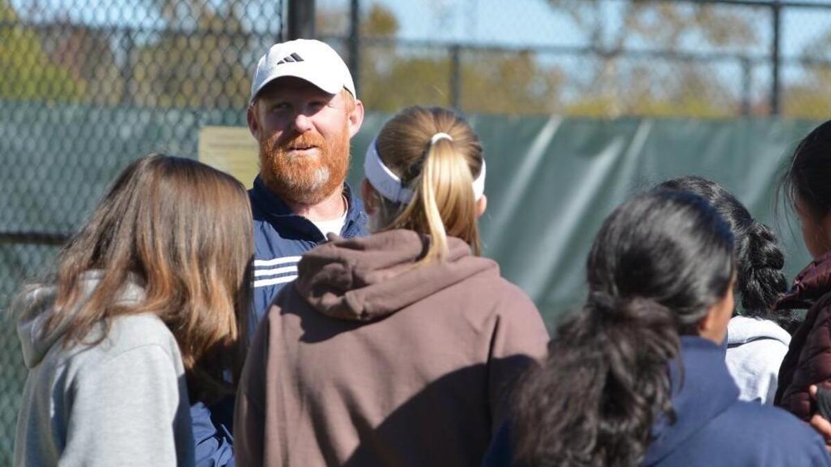 Richard McClenny, center, head coach of N.C. School of Science and Math talks to his players during the women dual team tennis games between the N.C. School of Science and Math Unicorns and the Lake Norman Charter Knights that took place at the Burlington Tennis Center in Burlington, N.C. on Saturday, November 12, 2016.