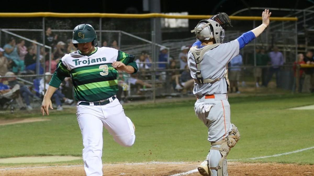 South Johnston's Jack Raynor (3) puts the Trojans in the lead in the bottom of the second inning as Glenn High catcher Drew Tiano (1) directs the defense. Coverage from the championship game of the Johnston County Easter Invitational Baseball Tournament between the Glenn High Bobcats and the South Johnston High Trojans played in Four Oaks, N.C. on Tuesday, April 11, 2017. South JohnstonÕs wins the championship 3-2 in extra innings.