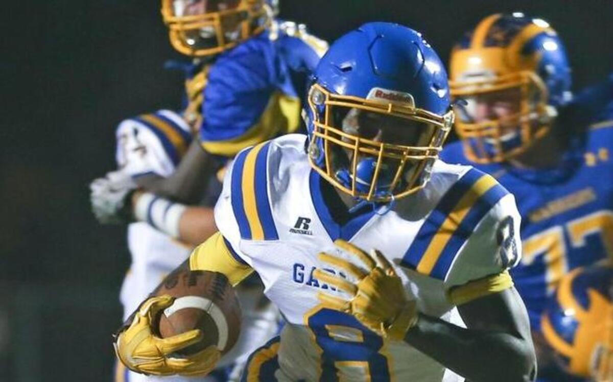 
Garner’s Collin Eaddy (8) breaks inside and puts the Trojans on the board to tie the game 6-6 in the first quarter. 
