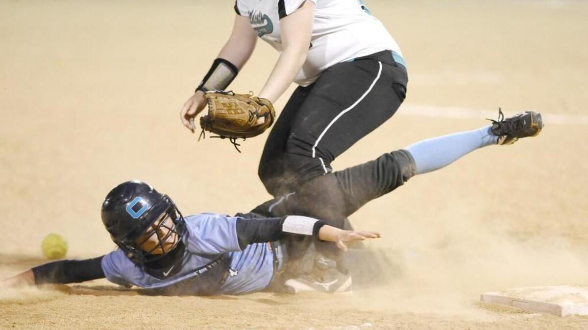 Cleveland’s Brook Hamlin (7) tries to reach third base before West Johnston’s Makayla Hackney (14) can get to the ball.