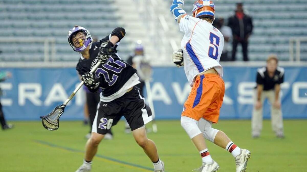 Carrboro's Brandon Richardson (20) and Marvin Ridge's Ben Cook (5) clashed during the NCHSAA 1A2A3A boys lacrosse state championship game, which was played in Raleigh on Friday, May 20, 2016. Marvin Ridge won 16-3.