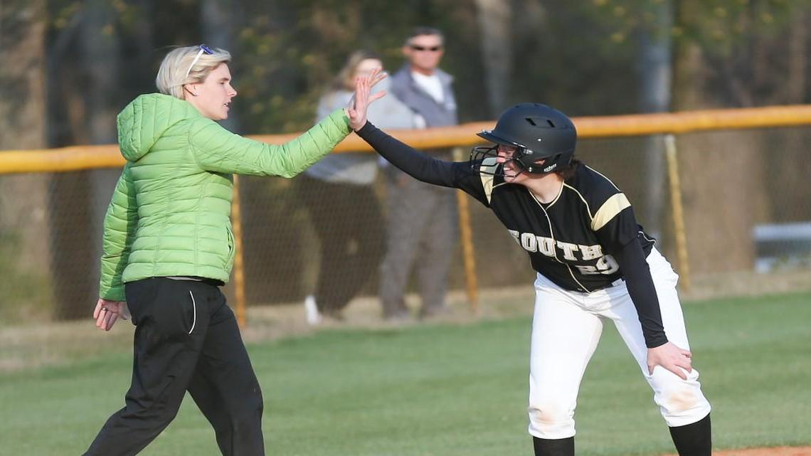 South Johnston coach Amanda Smith congratulates Emma Jernigan (29) who ends up being the winning run after getting home in the top of the 5th inning. Coverage from the prep softball double header between the Princeton Bulldogs and the South Johnston Trojans played n Four Oaks, N.C. on Friday, March 17, 2017. South Johnston defeated Princeton 6-2 in the first game and 4-3 in the second game.