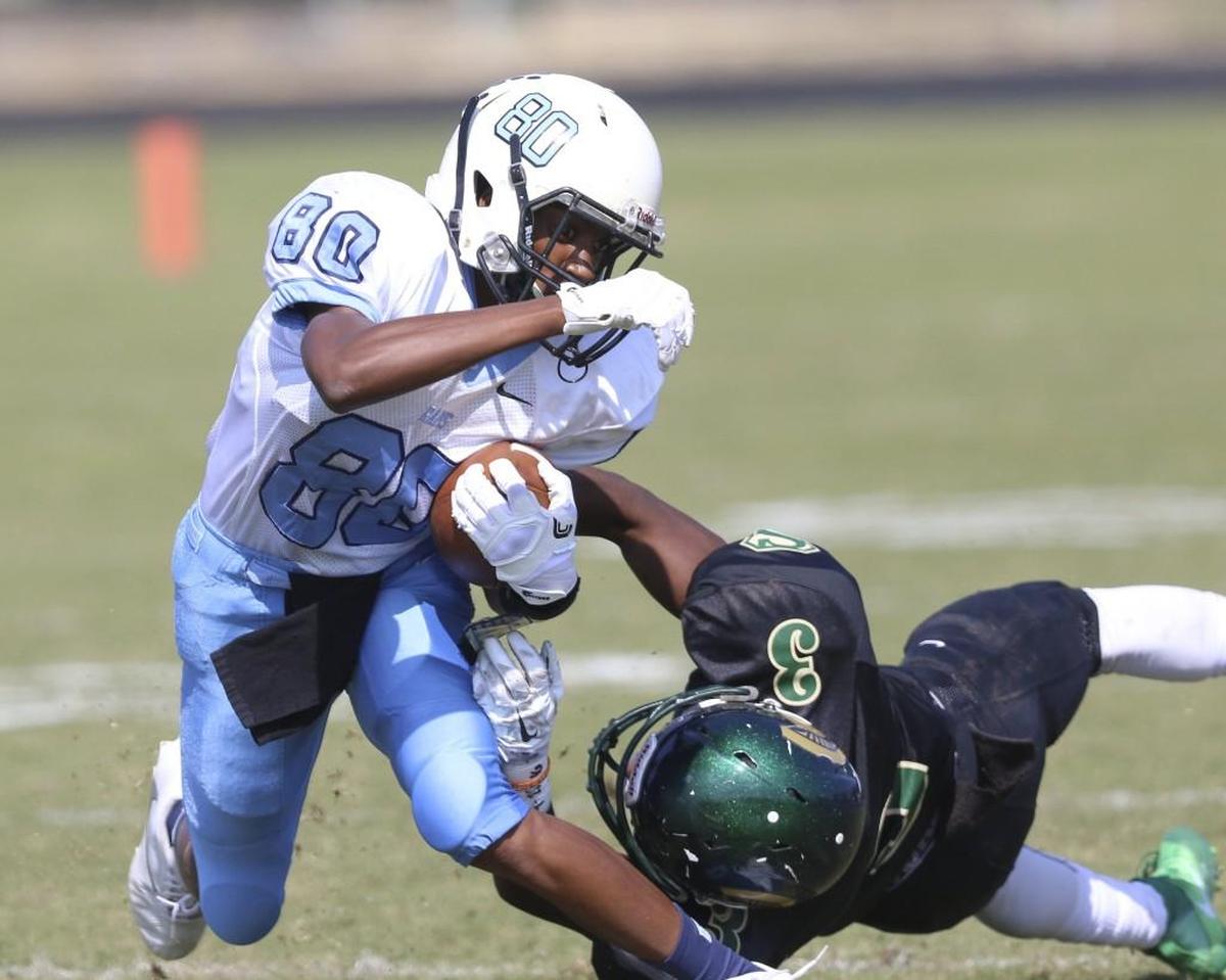 Cleveland's Jon Barnes (80) is brought down by South Johnston's Sharod Bailey (3) after big gain on the reception. Coverage from the prep football game between the Cleveland Rams and South Johnston Trojans played in Four Oaks, N.C. on Saturday, October 15, 2016. Cleveland defeated South Johnston 70-54 in Two Rivers 3A Conference contest.