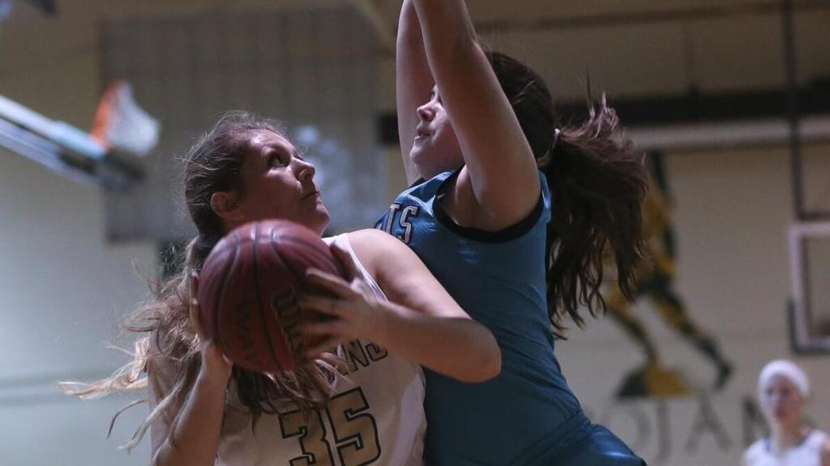 South Johnston’s Emma Blackman (35) goes up for a shot under the basket as West Johnston’s Kia Byrd (11) defends.