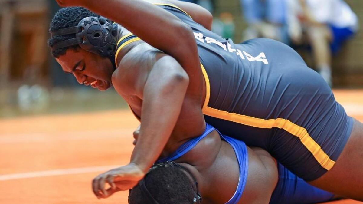 Apex’s Javon Jarrett (top) is able to pin Athens Drive's Bryce Void to win the Heavyweight match for the Cougars. Coverage from the dual wrestling meets between Fuquay-Varina, Athens Drive and Apex held in Fuquay-Varina, N.C. on Wednesday, December 16, 2015. Apex came away from the matches with wins over Athens Drive and Fuquay-Varina while Athens Drive defeated Fuquay-Varina.