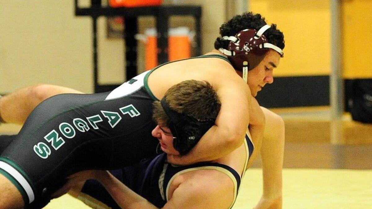 Green Hope’s Andrew Becvar (top) and Holly Springs' J. Josey wrestle in the 195 pound class during the wrestling match, which took place in Holly Springs on Tuesday, December 8, 2015. Holly Springs won 54-27.